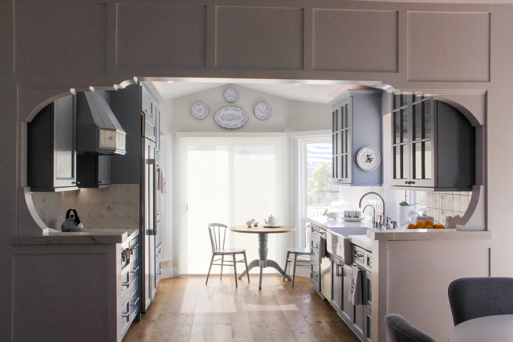 Blue-gray custom kitchen with an arched opening